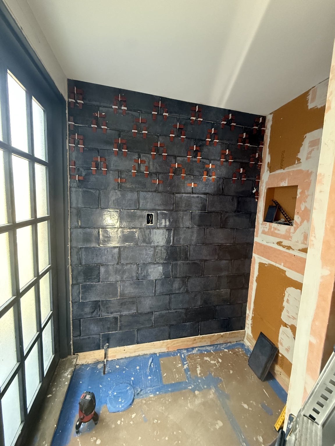 Tiling in progress with leveling clips